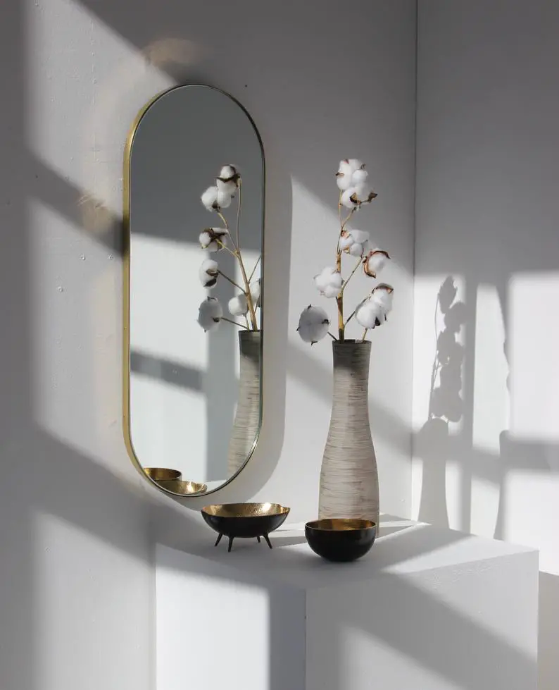 Capule shaped arch mirror with brass frame